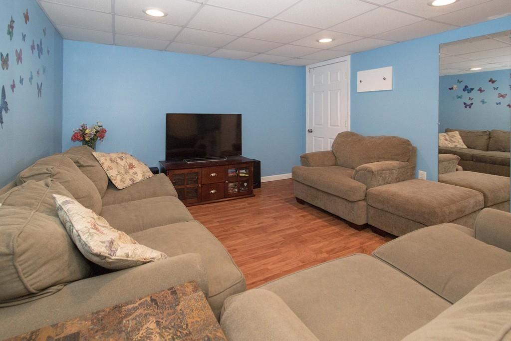 59 Warren Road Framingham, MA 01702 - Photo 14 of 25 a living room with furniture and a flat screen tv