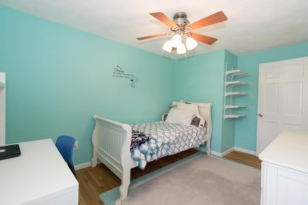 59 Warren Road Framingham, MA 01702 - Photo 17 of 25 a room with a bed and a chandelier