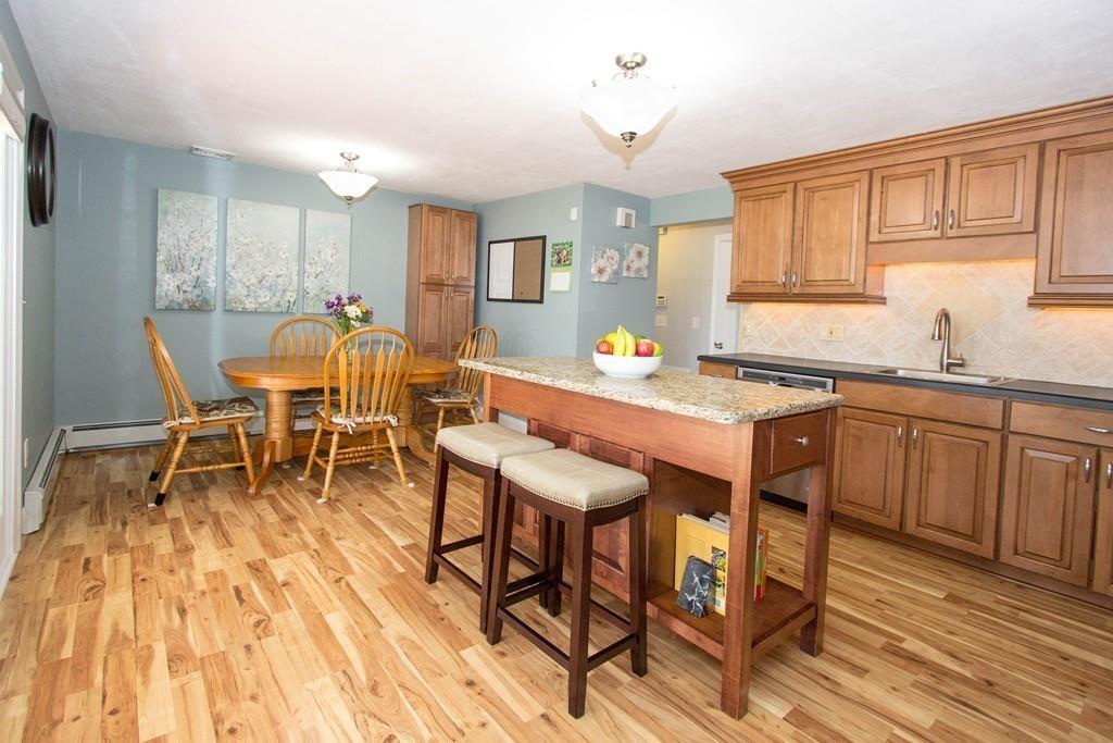59 Warren Road Framingham, MA 01702 - Photo 5 of 25 a view of a dining room with furniture and wooden floor
