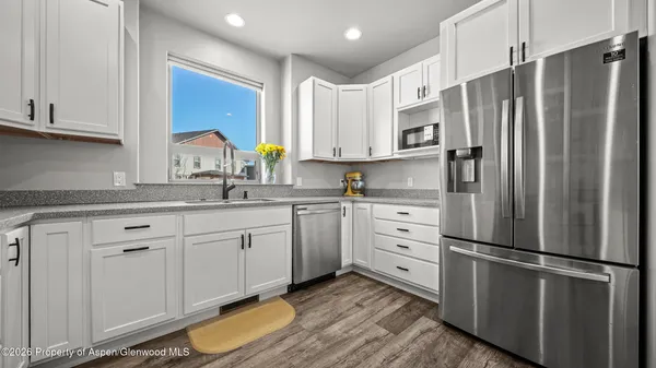 a kitchen with stainless steel appliances a refrigerator sink and cabinets