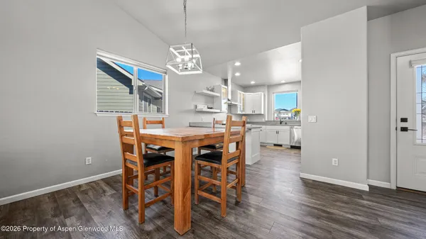 a view of a dining room with furniture and wooden floor