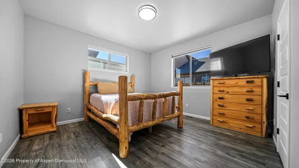 a bedroom with furniture and a flat screen tv