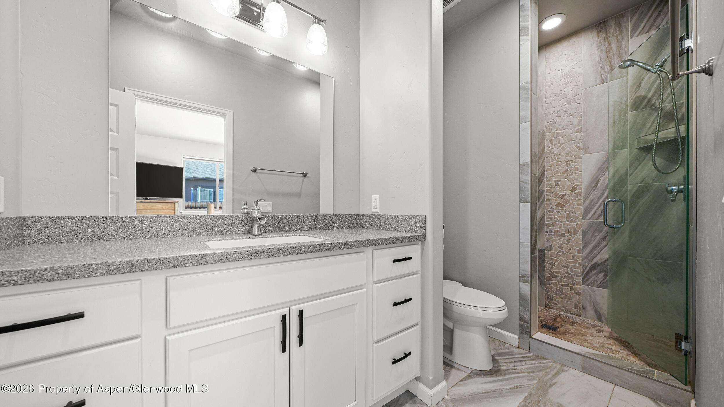 1667 Balsam Loop Rifle, CO 81650 - Photo 15 of 30 a bathroom with a granite countertop sink toilet and shower