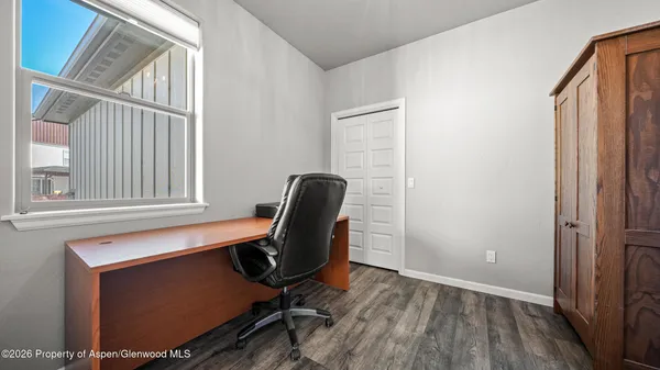 a view of workspace with wooden floor windows