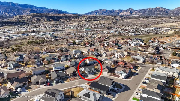 an aerial view of a houses with a mountain