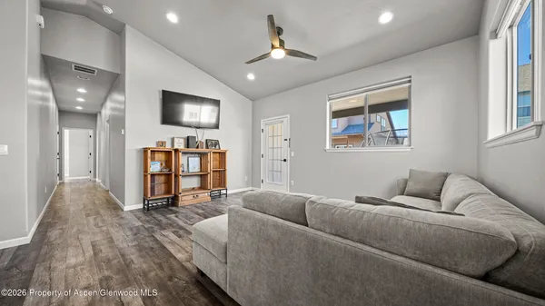 a living room with furniture and a flat screen tv