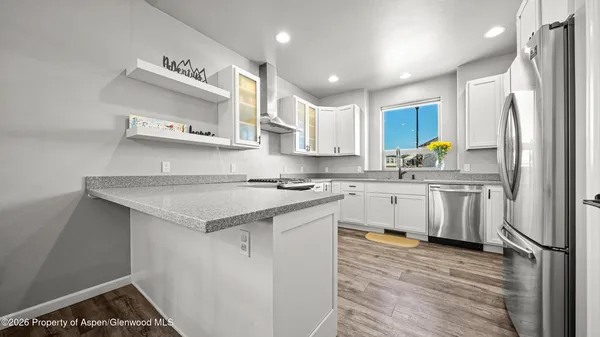 a kitchen with stainless steel appliances a sink stove and refrigerator