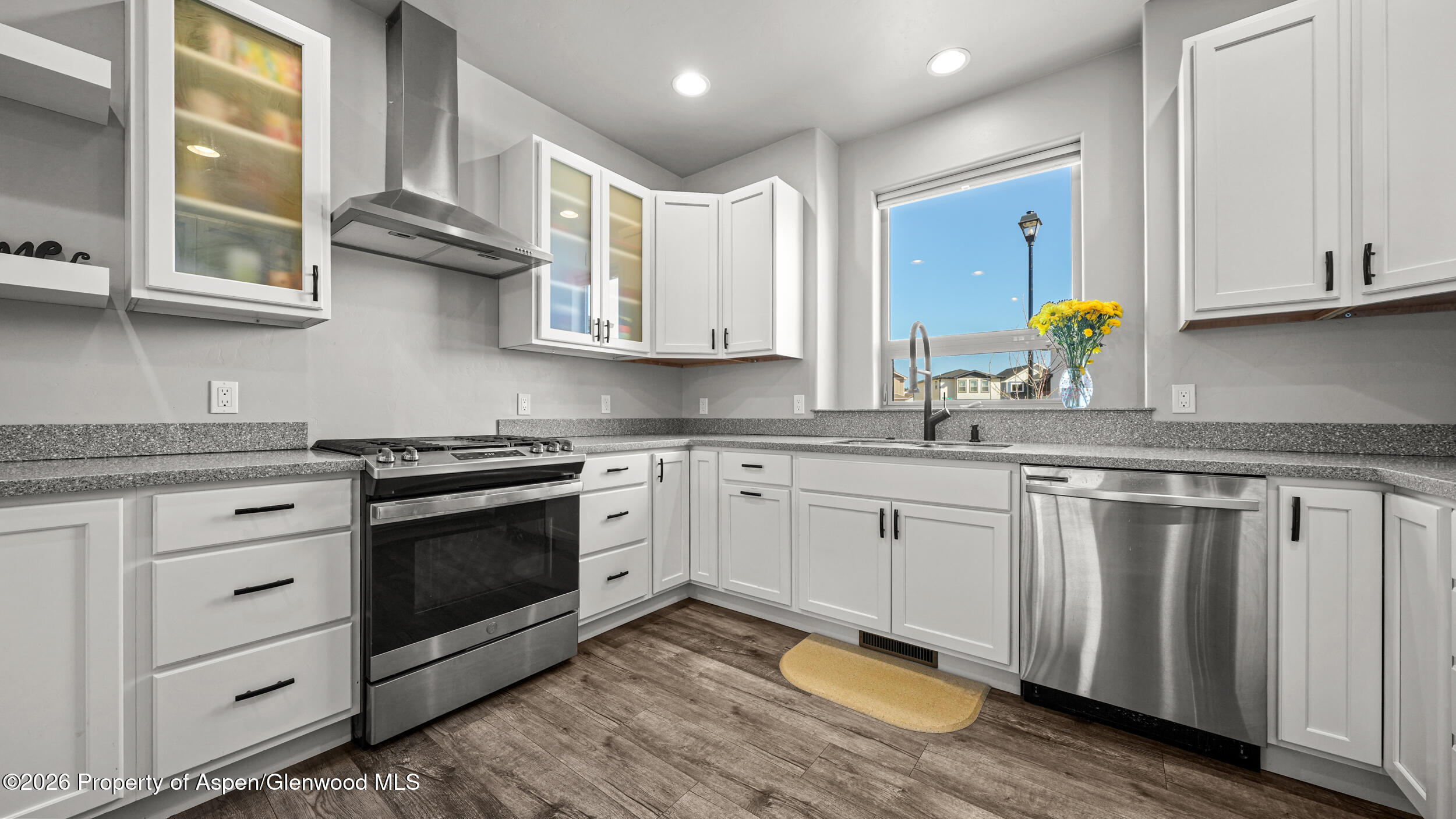 1667 Balsam Loop Rifle, CO 81650 - Photo 10 of 30 a kitchen with stainless steel appliances granite countertop a sink cabinets and wooden floor