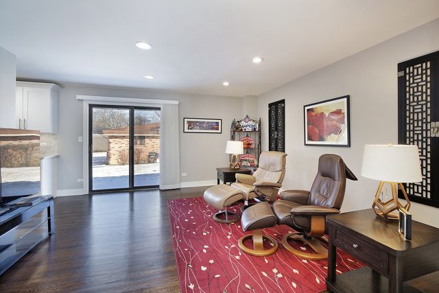a living room with furniture a wooden floor and a window