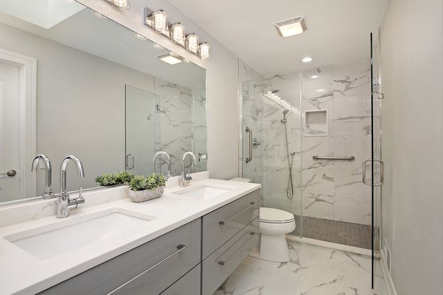 a bathroom with double sink and a mirror