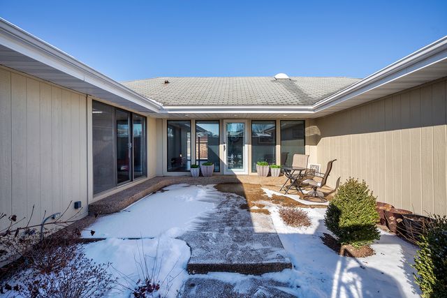 a front view of a house with sitting area