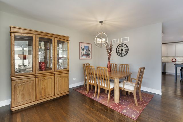 a view of a dining room with furniture wooden floor and chandelier