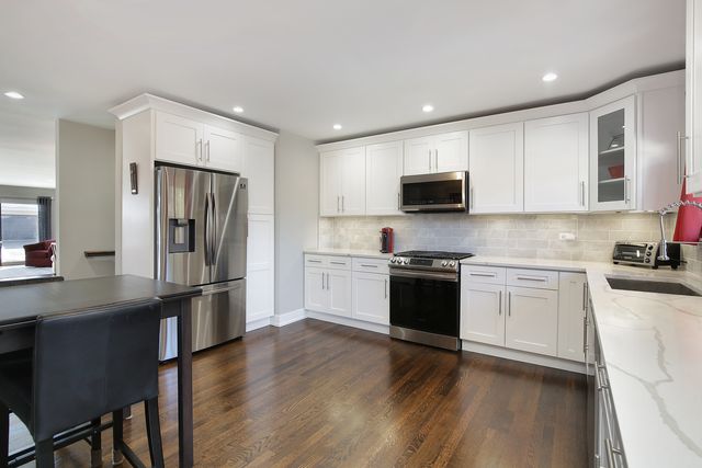 a kitchen with a refrigerator stove and microwave