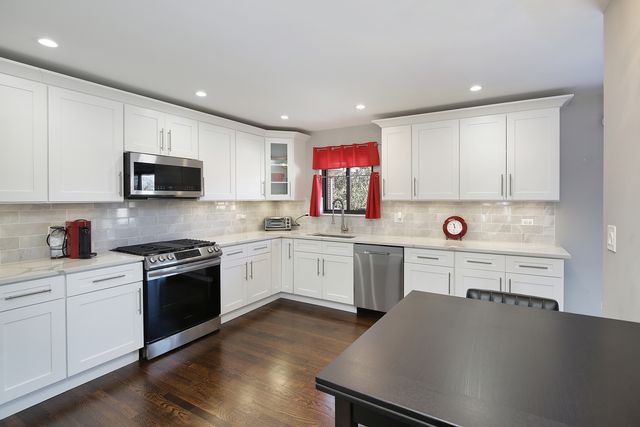 a kitchen with a sink a stove a microwave and cabinets