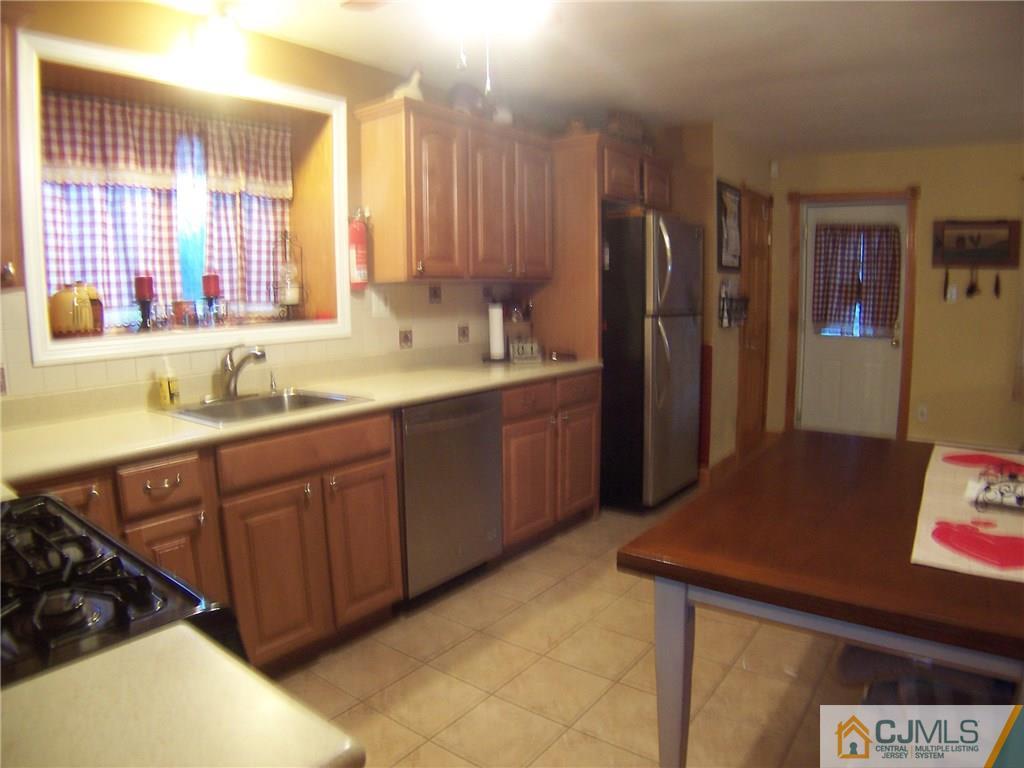 30 Oxford Road Colonia, NJ 07067 - Photo 3 of 17 a kitchen with stainless steel appliances a sink stove and refrigerator