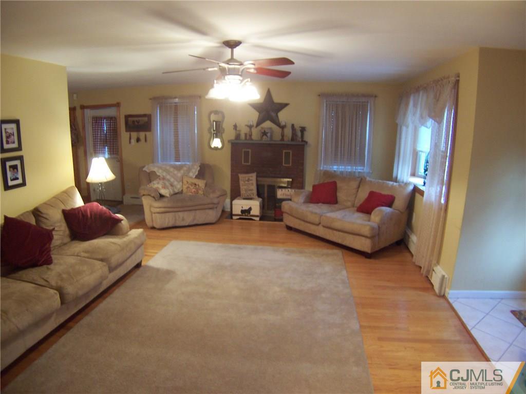 30 Oxford Road Colonia, NJ 07067 - Photo 4 of 17 a living room with furniture and a chandelier