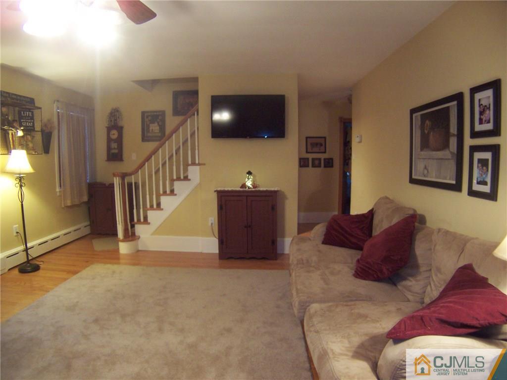 30 Oxford Road Colonia, NJ 07067 - Photo 5 of 17 a living room with a couch and a flat screen tv