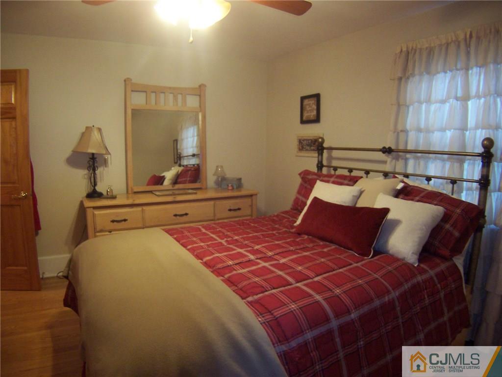 30 Oxford Road Colonia, NJ 07067 - Photo 6 of 17 a bedroom with a bed and a mirror on dresser