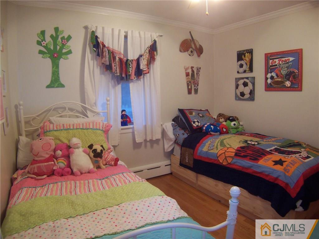 30 Oxford Road Colonia, NJ 07067 - Photo 10 of 17 a bedroom with a bed and a baby bed