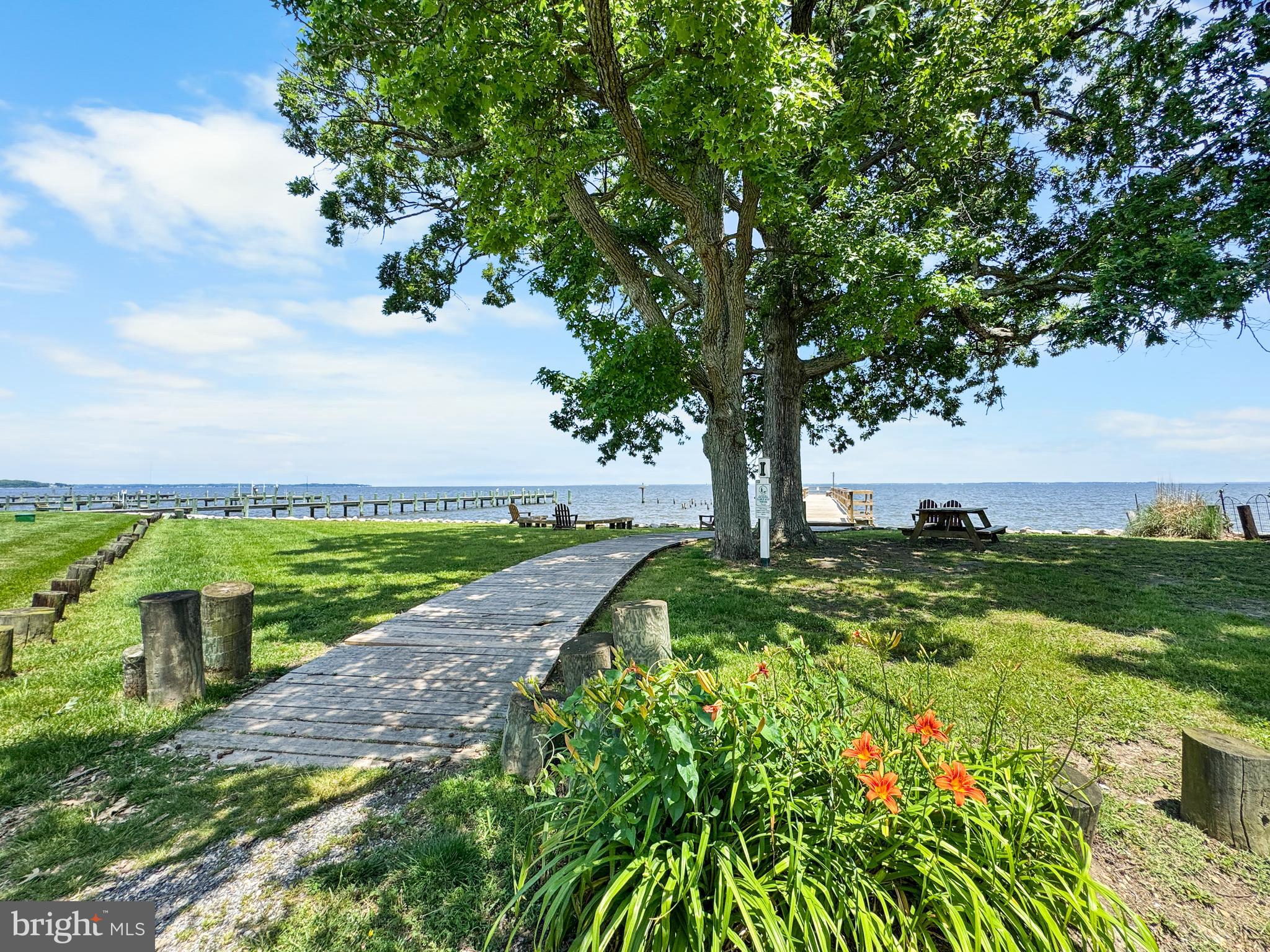 4725 Idlewilde Road Shady Side, MD 20764 - Photo 18 of 28 a view of a garden with a building in the background