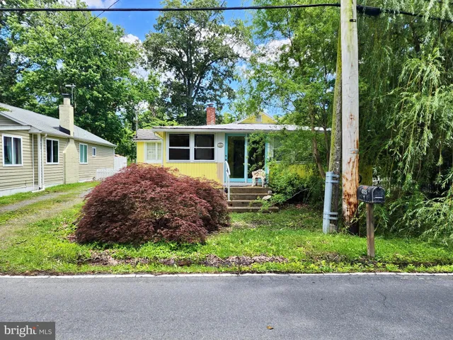 a house with a big yard and large trees