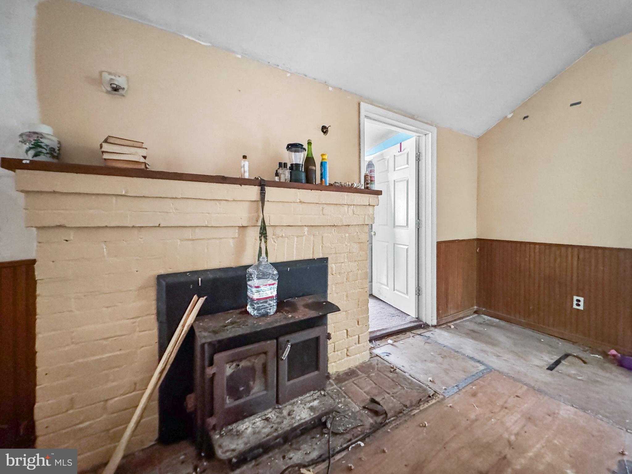 4725 Idlewilde Road Shady Side, MD 20764 - Photo 4 of 28 a living room with furniture and a fireplace