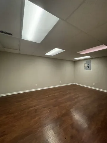a view of a room with wooden floor