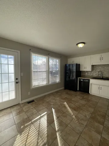 a view of a kitchen with a sink and cabinets