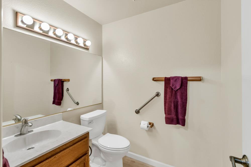 7025 Rancho Mirage Court Citrus Heights, CA 95621 - Photo 18 of 69 a bathroom with a toilet a sink and mirror
