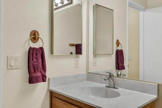 a kitchen with stainless steel appliances granite countertop a sink a stove and a refrigerator