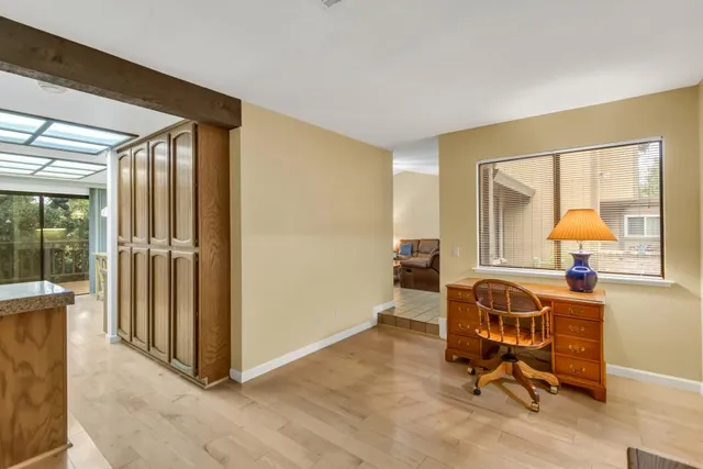 a kitchen with granite countertop a sink a stove and cabinets