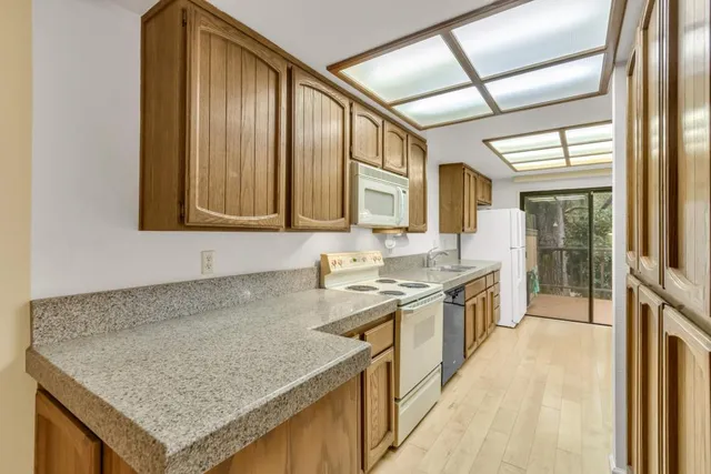 a kitchen with stainless steel appliances granite countertop sink stove and cabinets
