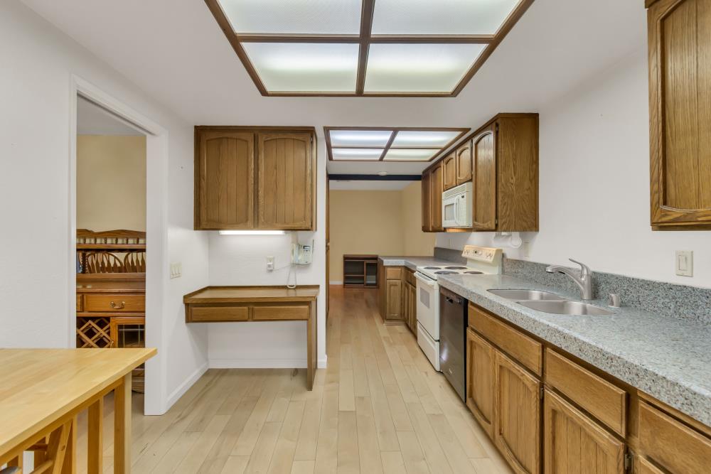 7025 Rancho Mirage Court Citrus Heights, CA 95621 - Photo 26 of 69 a large kitchen with kitchen island a stove a sink and a refrigerator
