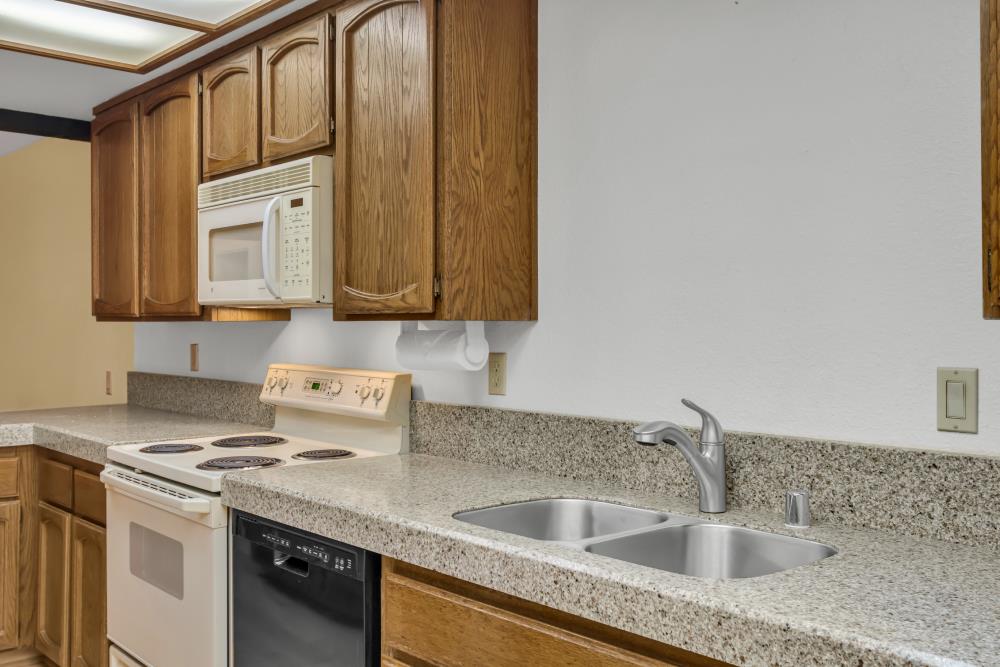 7025 Rancho Mirage Court Citrus Heights, CA 95621 - Photo 27 of 69 a kitchen with granite countertop a sink a stove and cabinets