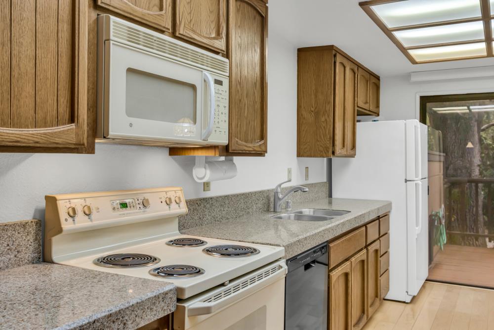 7025 Rancho Mirage Court Citrus Heights, CA 95621 - Photo 28 of 69 a kitchen with a stove a sink and a refrigerator