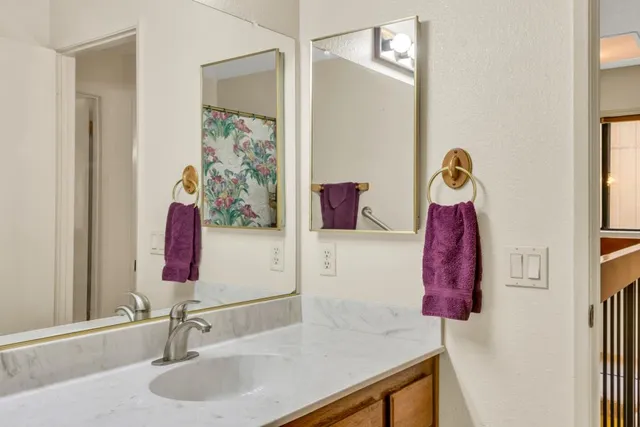 a view of roof deck with wooden floor and fence