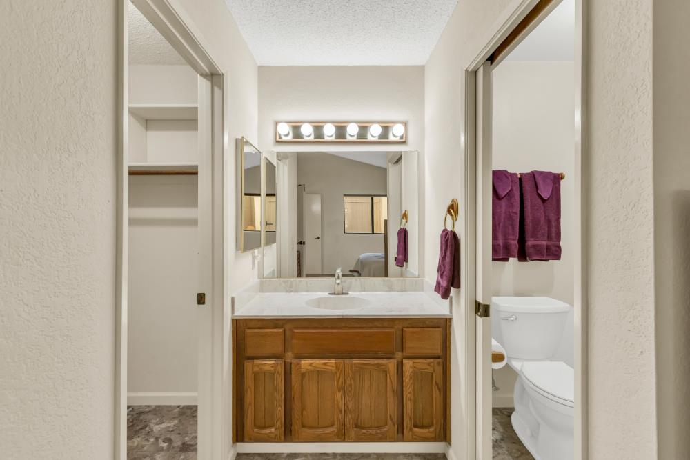 7025 Rancho Mirage Court Citrus Heights, CA 95621 - Photo 46 of 69 a bathroom with a granite countertop sink and a mirror