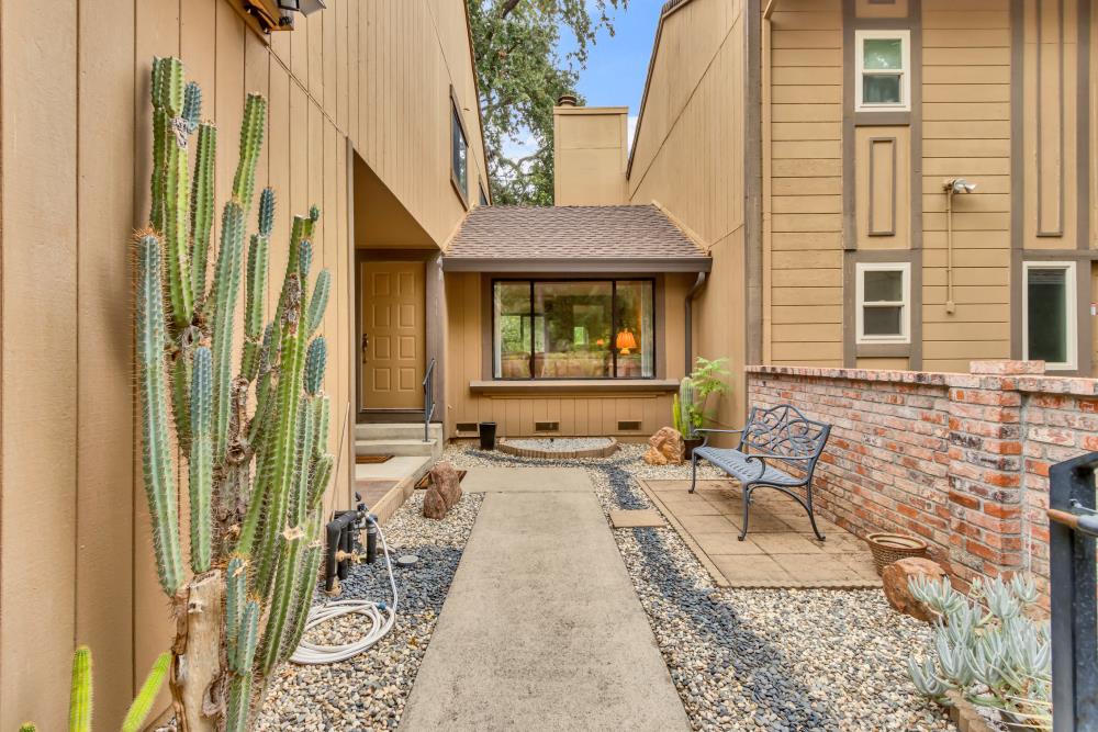 7025 Rancho Mirage Court Citrus Heights, CA 95621 - Photo 6 of 69 a view of a brick house with large windows and furniture