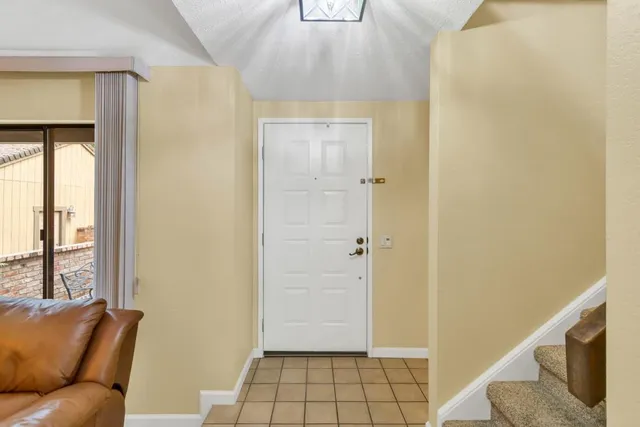 a dining room with furniture a chandelier and wooden floor