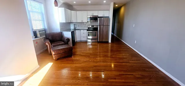 a kitchen with stainless steel appliances a refrigerator and a stove top oven