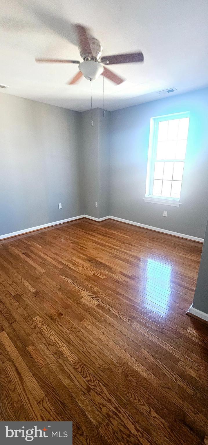 362 West Ritner Street, Unit 3 Philadelphia, PA 19148 - Photo 12 of 13 a view of an empty room with wooden floor and a window