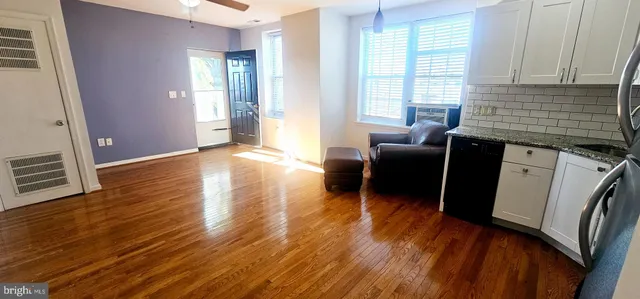 a living room with furniture window and wooden floor