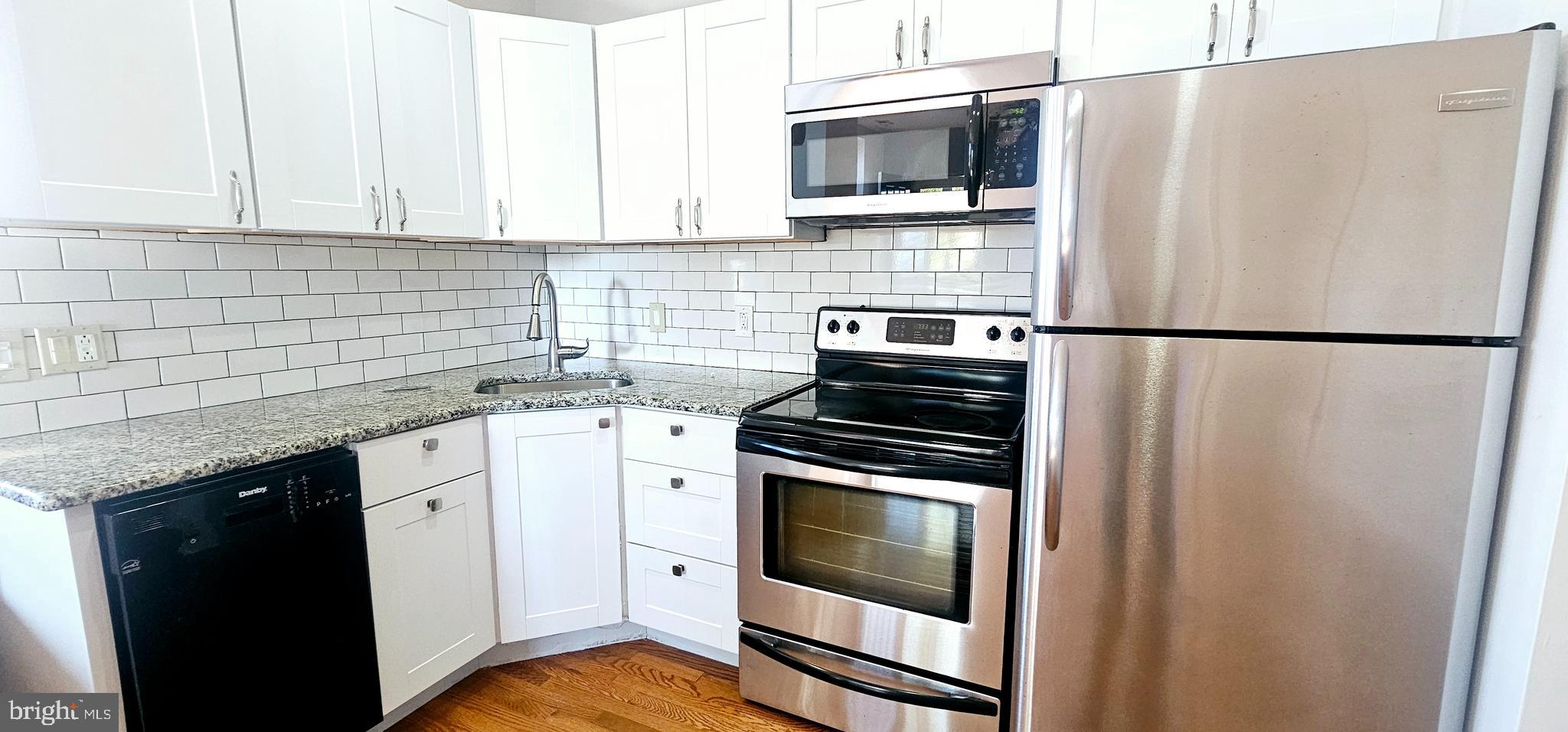 362 West Ritner Street, Unit 3 Philadelphia, PA 19148 - Photo 4 of 13 a kitchen with stainless steel appliances a refrigerator sink and microwave