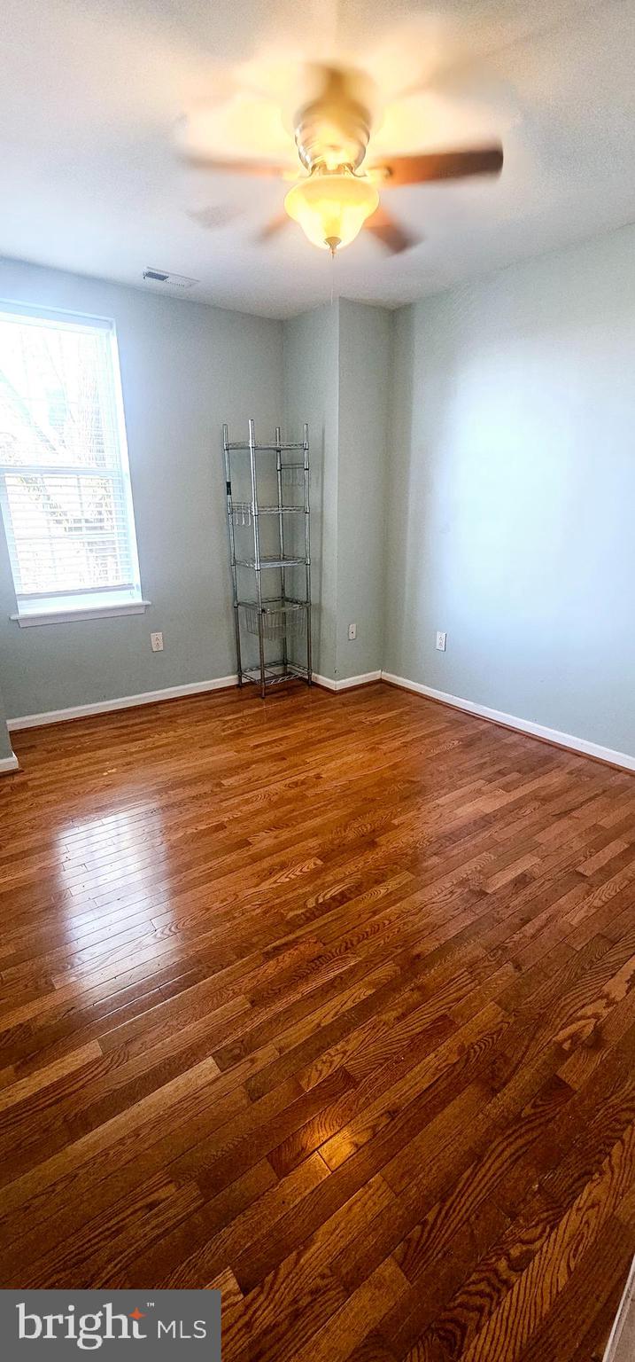 362 West Ritner Street, Unit 3 Philadelphia, PA 19148 - Photo 10 of 13 a view of an empty room with window and wooden floor