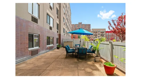 a view of a patio with a dining table and chairs