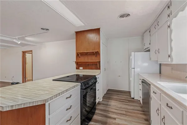 a kitchen with a sink stove and refrigerator