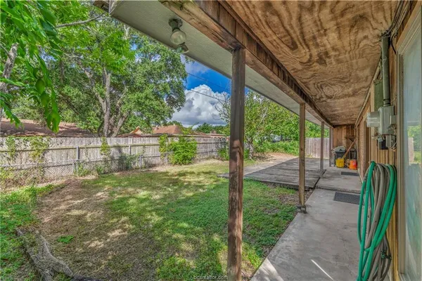 a view of a yard with a trees in the background