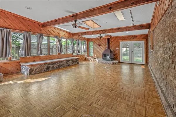 a spacious bedroom with a bed and a large window