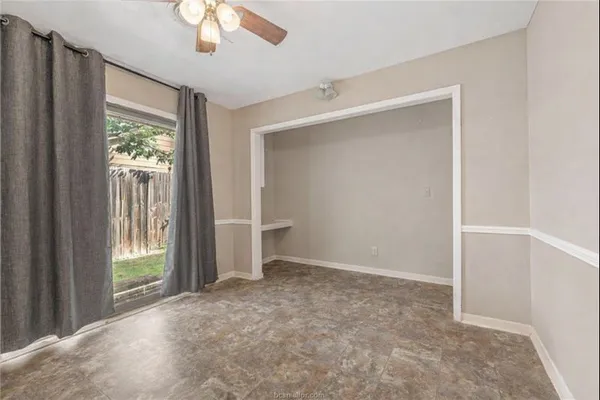 an empty room with windows and closet