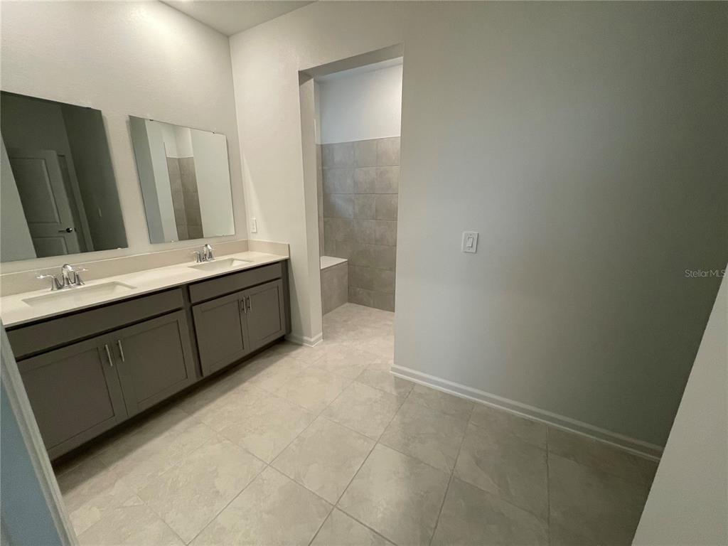 2623 Runners Circle Clermont, FL 34714 - Photo 16 of 21 a bathroom with a double vanity sink and mirror